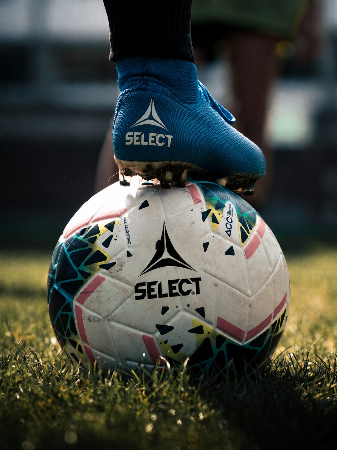 Soccer player preparing for competition with a ball on the field