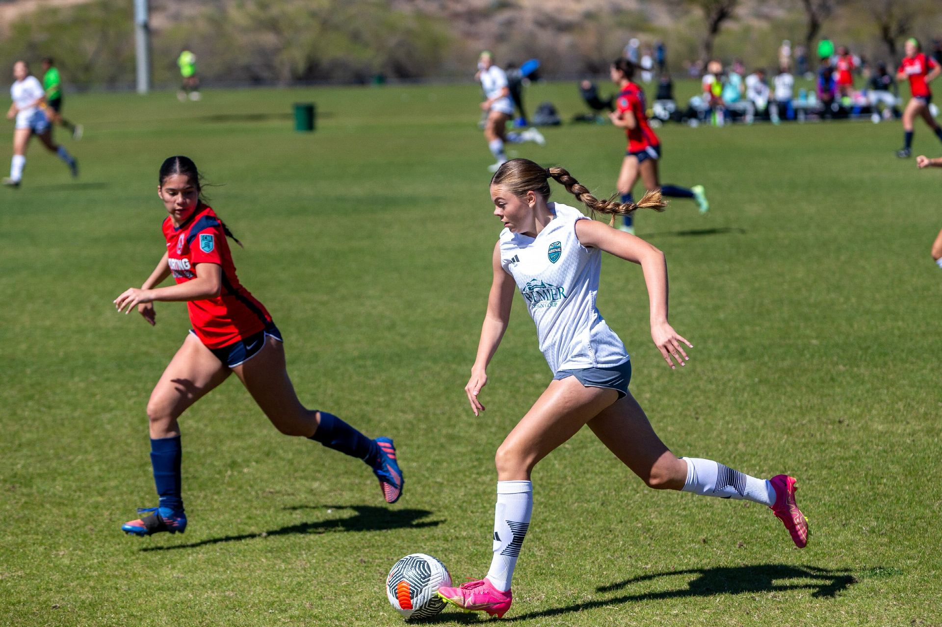 High school-age soccer players competing on a St. Louis-area field